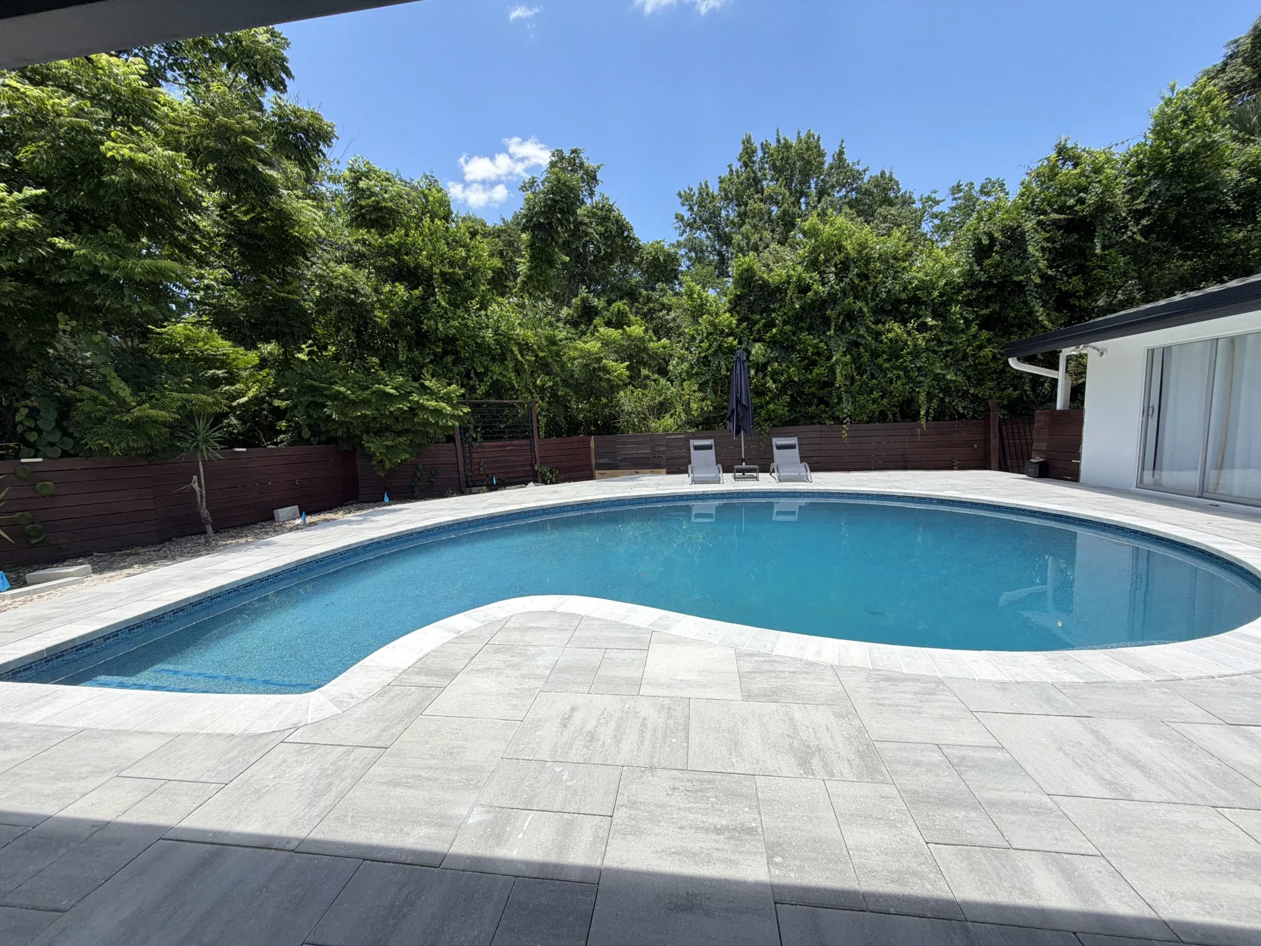 Completed pool resurfacing with PebbleTec finish in Orlando Florida showing results after answering all homeowner questions with D&J The Pool Resurfacers