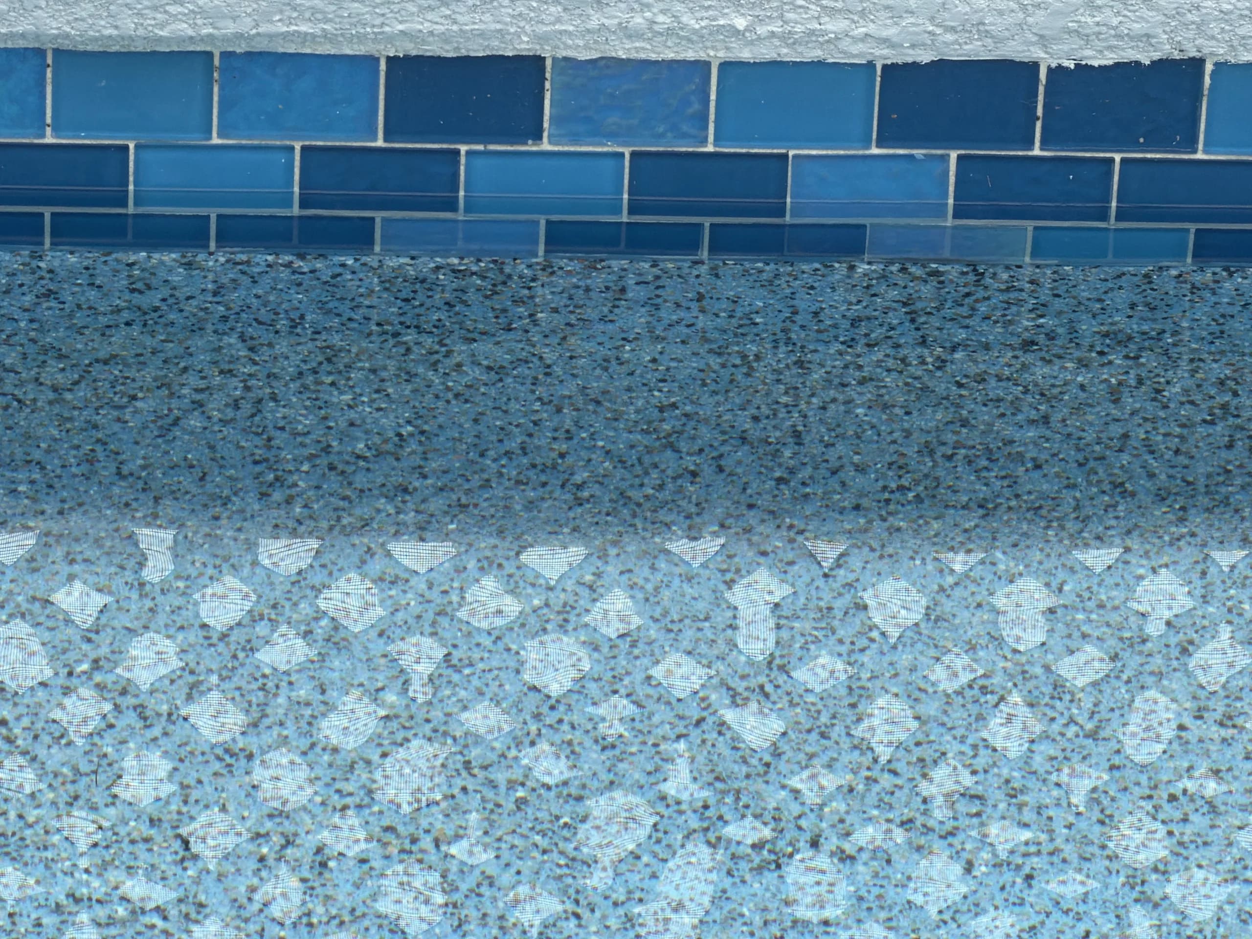 PebbleTec and Quartz pool finish color samples being reviewed for HOA approval in Orlando Florida community