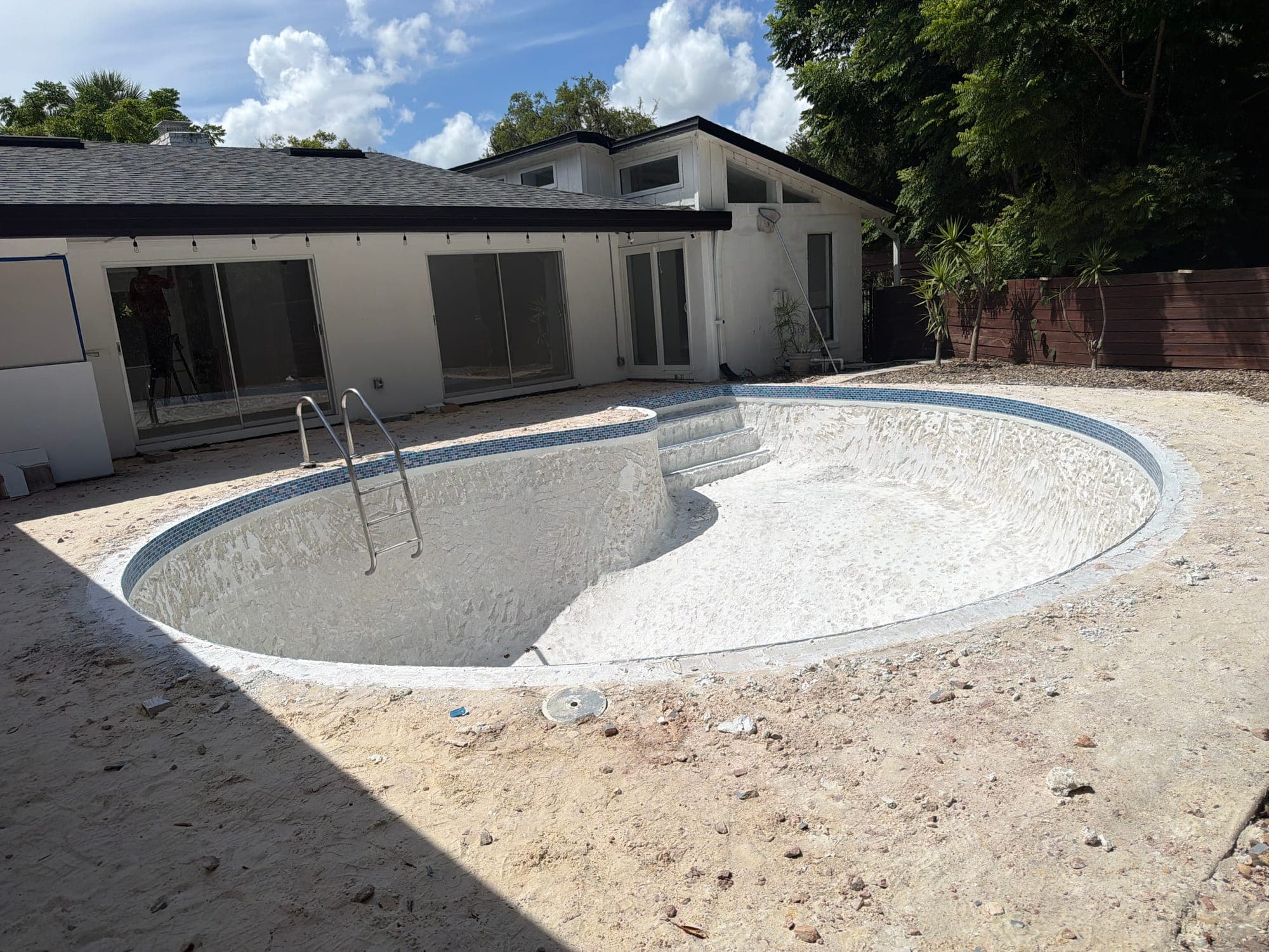 Empty pool with the old finish removed, prepped for the new surface