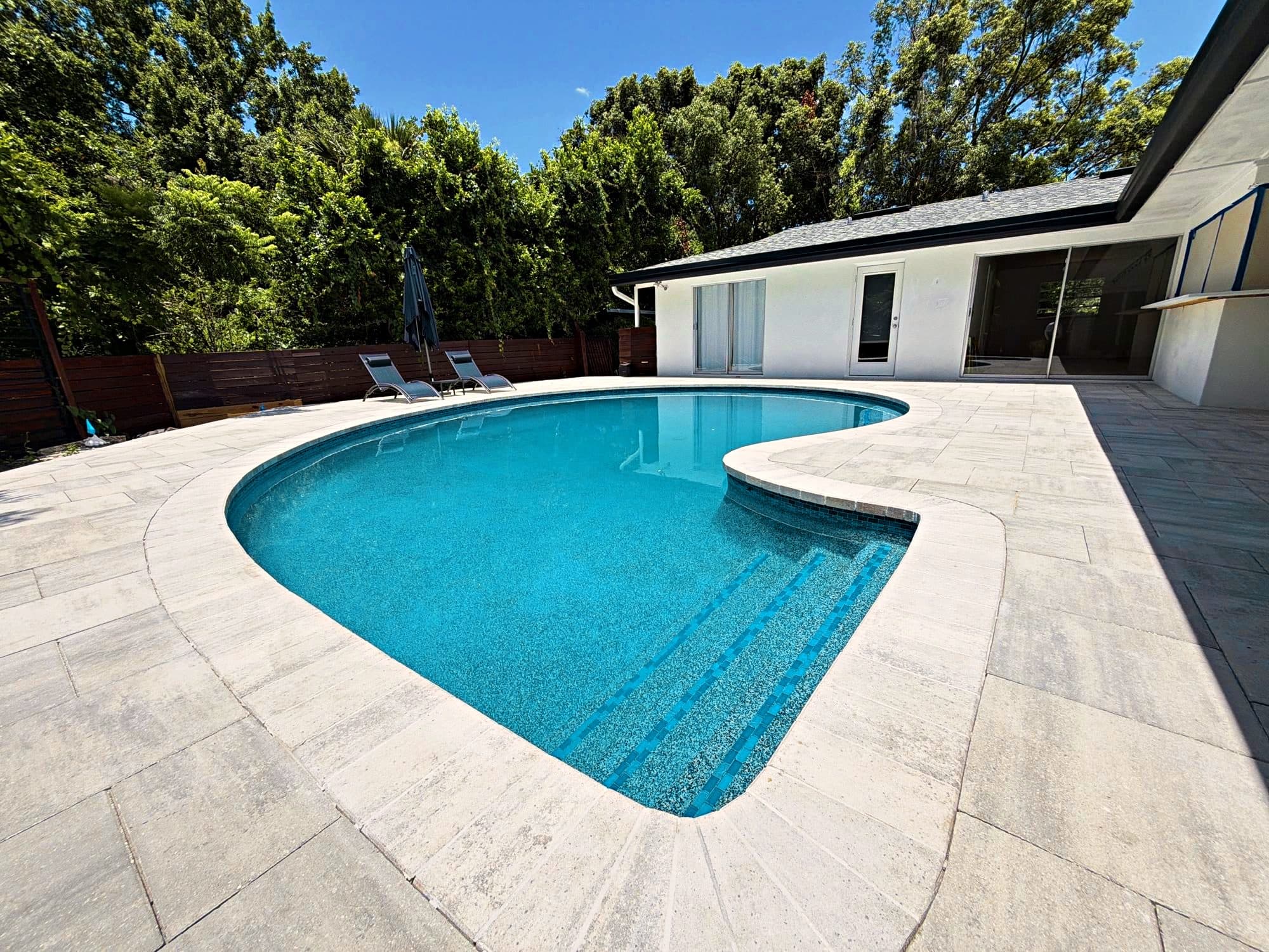 Finished pool with a new paver deck by D&J