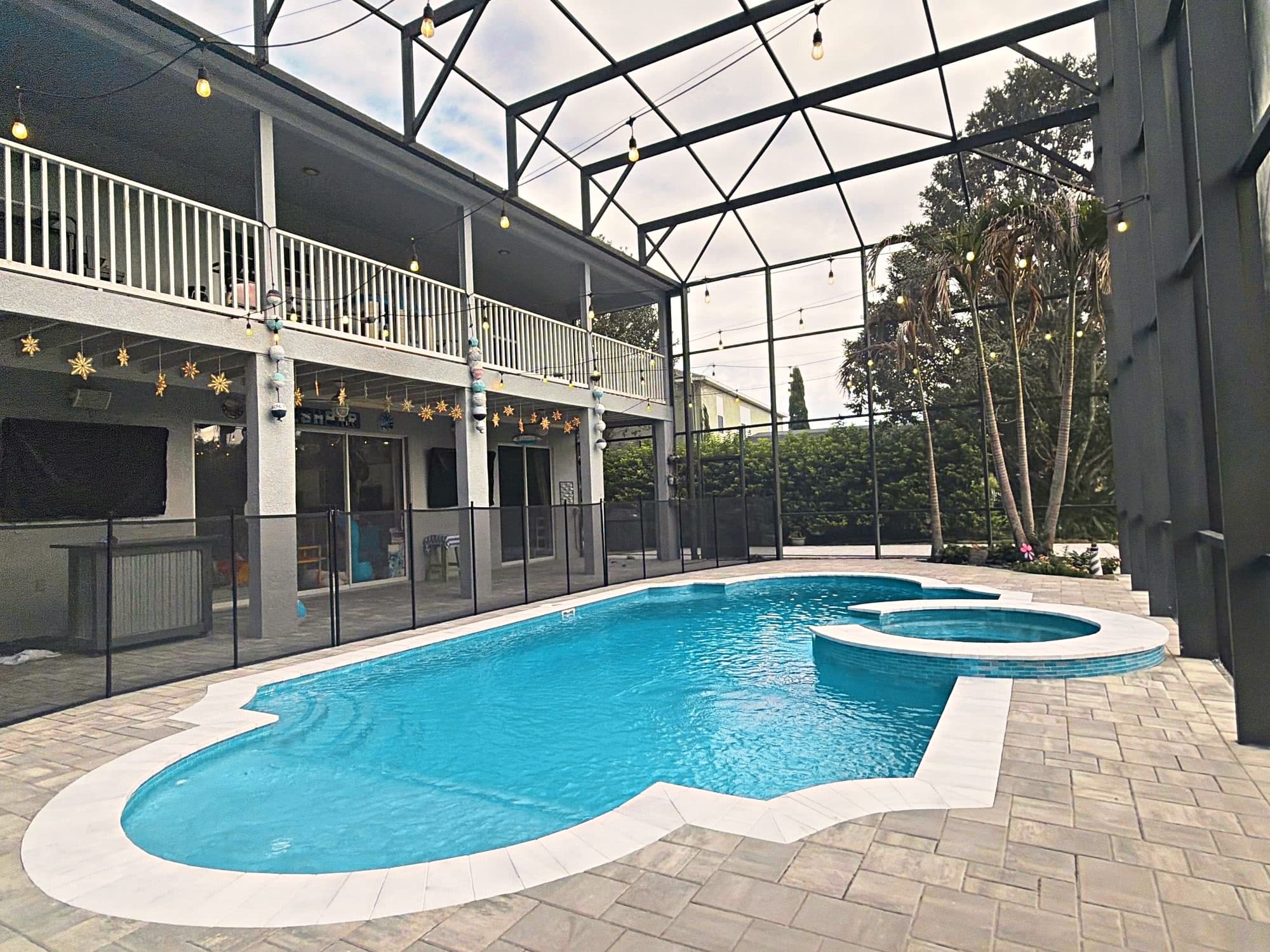 Resurfaced pool and spa under a screen enclosure