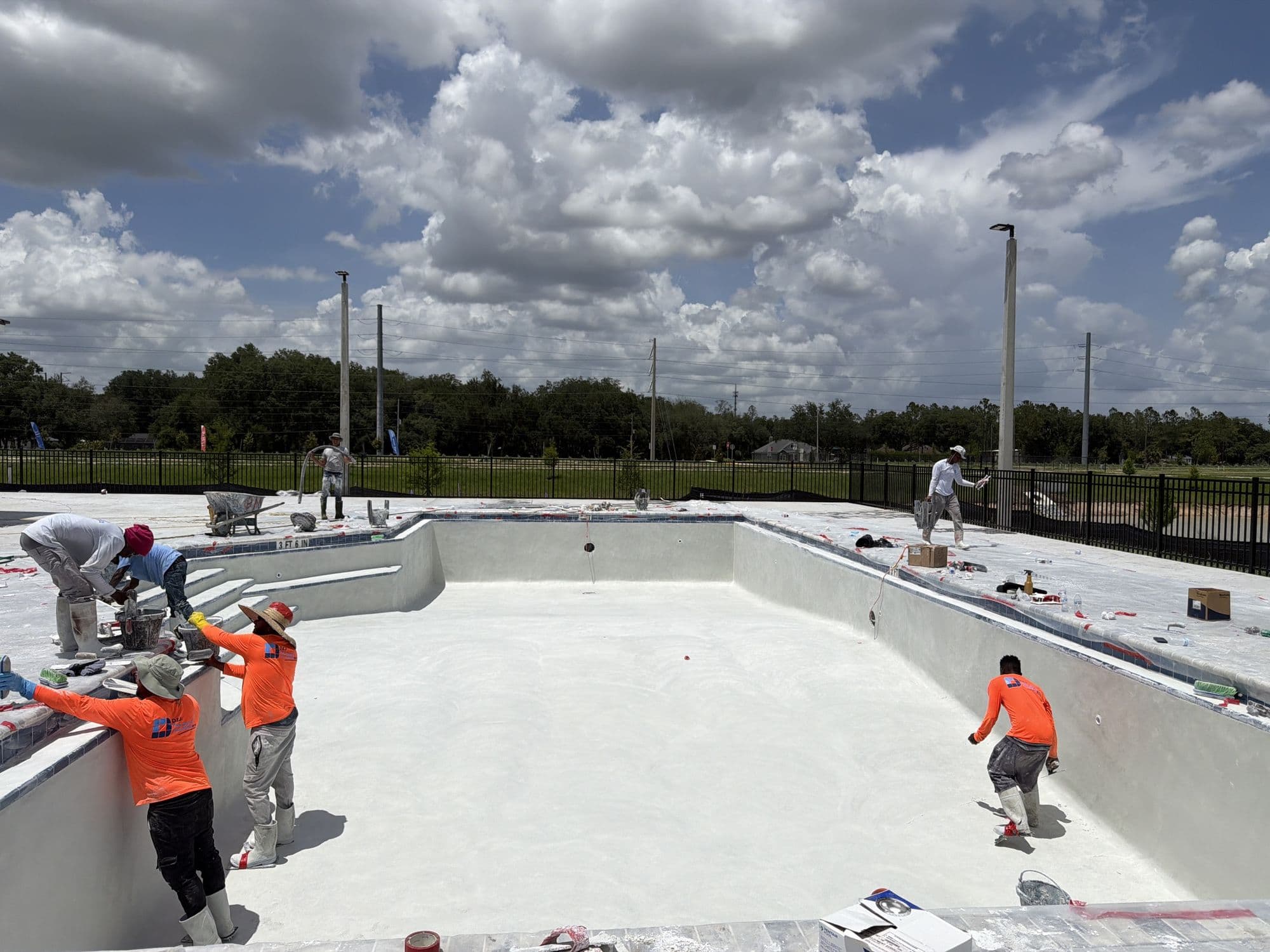 D&J crew resurfacing a large commercial pool