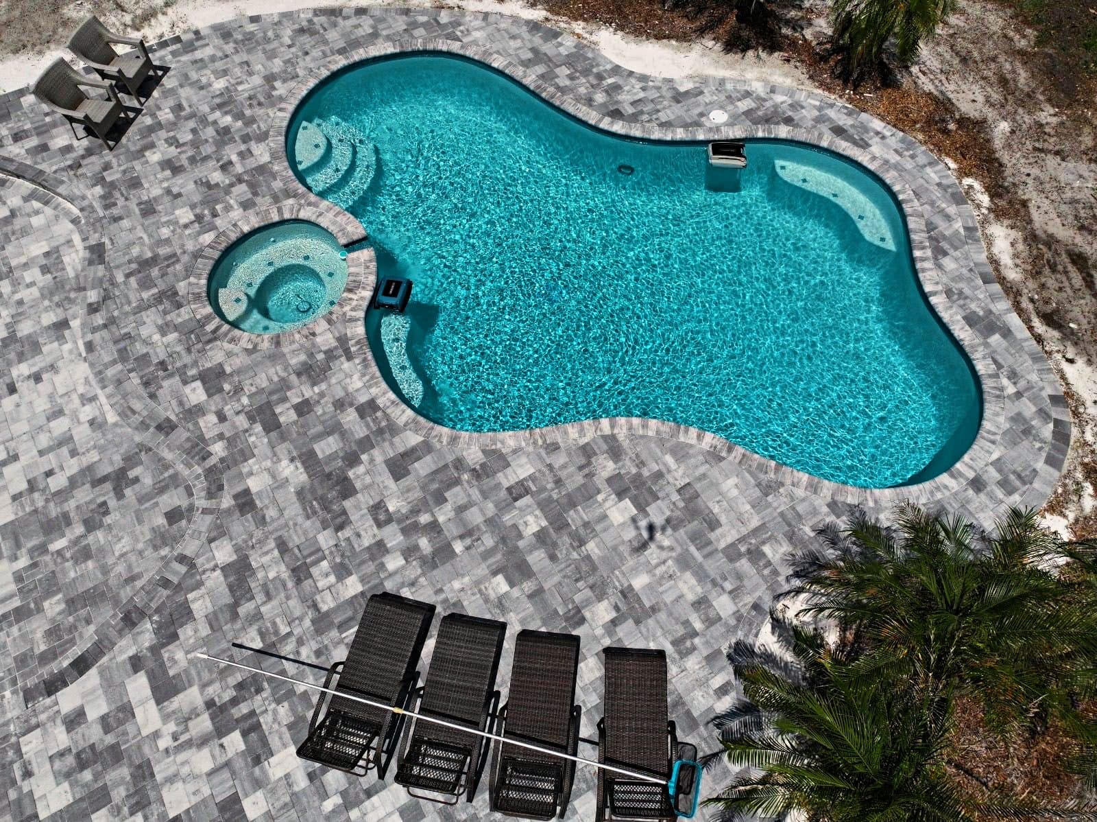 Aerial view of a renovated freeform pool and spa