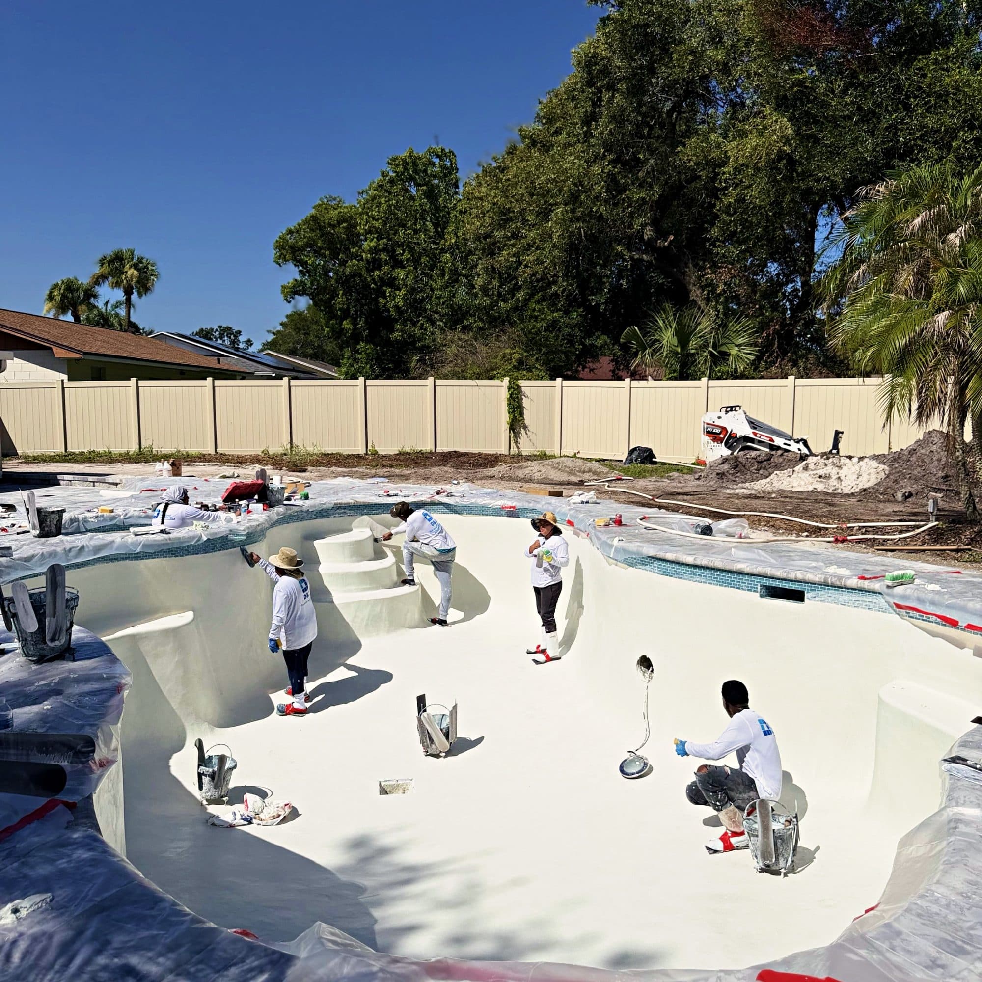 Hand-finishing the floor of a new pool