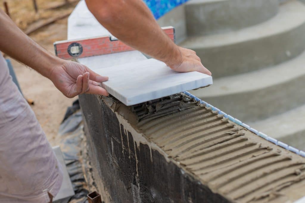 a technician lays tiles in a swimming pool select 2026 01 09 13 12 52 utc