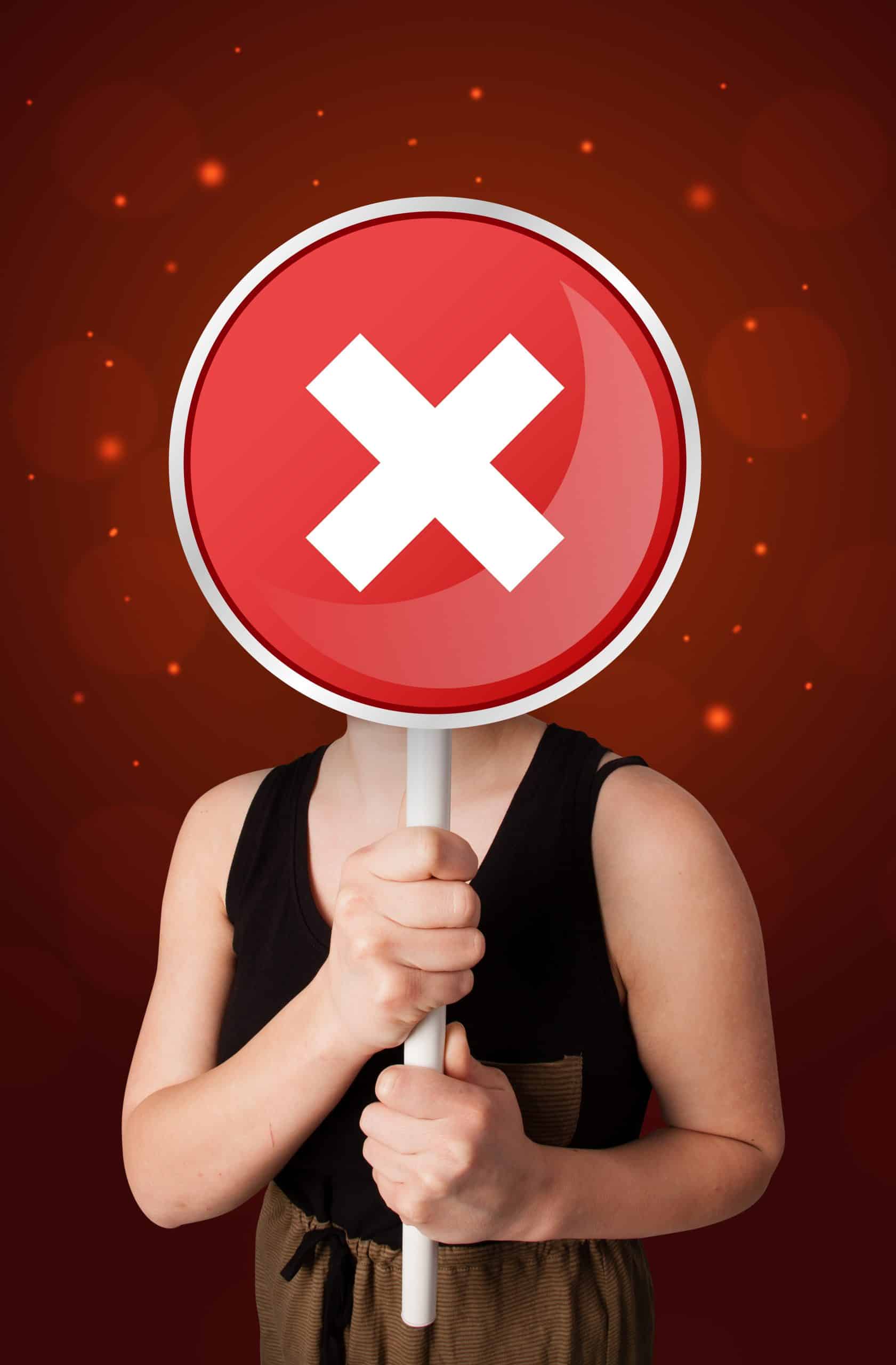 casual young woman holding round red sign with whi 2026 01 09 14 43 35 utc