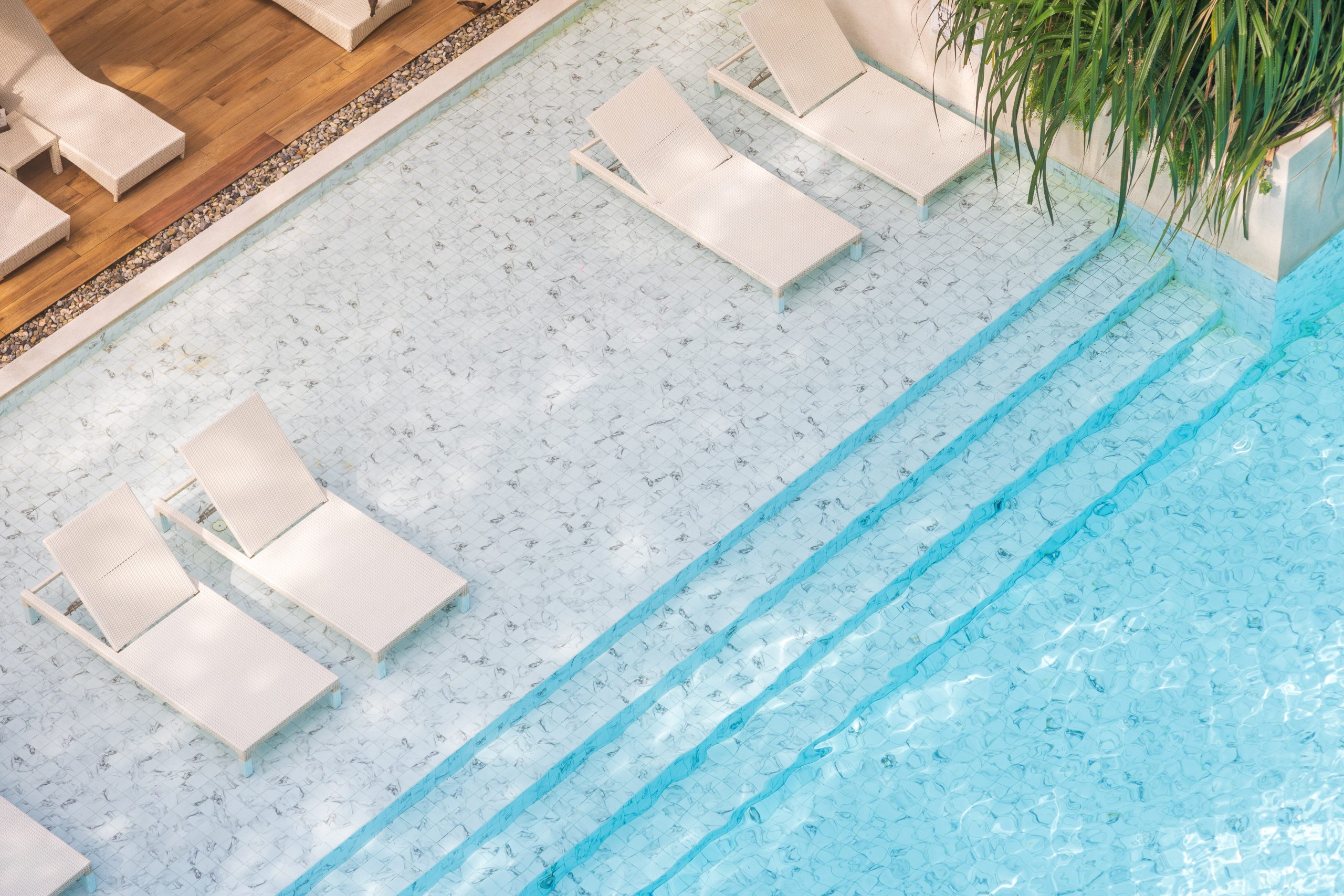 high angle of luxury swimming pool in an exclusive 2026 03 18 07 50 18 utc PebbleTec commercial pool finish Florida — high-traffic pool resurfacing